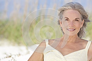 Attractive Elegant Senior Woman Sitting At A Beach