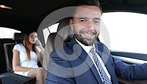 Attractive elegant serious man drives good car