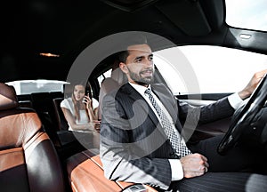 Attractive elegant serious man drives good car