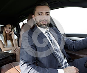 Attractive elegant serious man drives good car