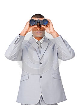 Attractive Ethnic businessman using binoculars