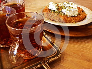 Attractive evening table , with fragrant tea and Turkish baklava called kunafa photo