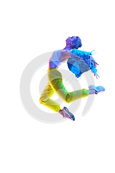 Attractive excited fitness girl dancer in sportwear dance in neon light in air isolated over white background.