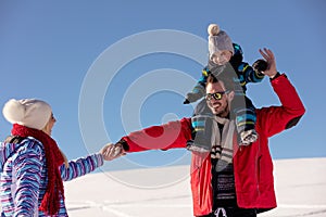 Attractive family having fun in a winter park on mountain