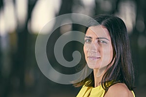 Attractive and fashionable young woman with a yellow dress in na