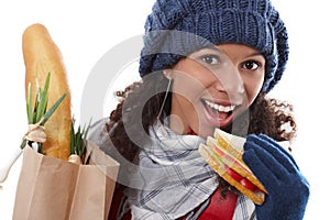 Attractive female biting sandwich at wintertime