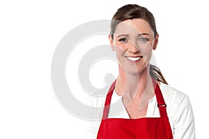Attractive female chef wearing red apron