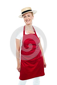 Attractive female chef wearing red apron and hat