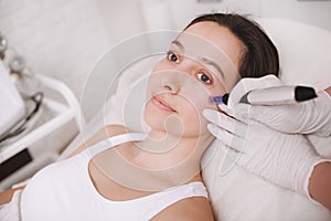 Young woman getting facial skincare treatment photo