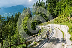 Attractive female cyclist tackling a steep road.