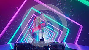 Attractive female on digital wall colorful visual graphic background. Young woman dj dancing, plays music on turntables