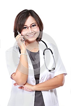 Attractive female doctor in lab coat with stethoscope talking wi