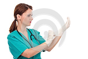 Attractive female doctor putting sterilized surgical gloves