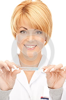 Attractive female doctor with thermometer