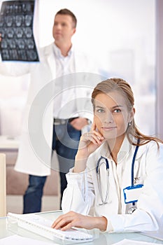 Attractive female doctor working on computer