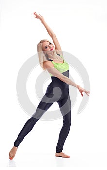 Attractive female gymnast exercising at studio