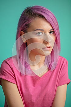 Attractive female with pink hair, stylish haircut, dressed in pink t-shirt