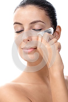 Attractive female removing eye make up