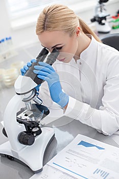 Attractive female scientist is doing her research