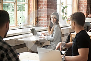 Attractive female smiling to male colleague flirting with her