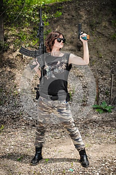 Attractive female soldier with riffle machine gun. Woman with weapon