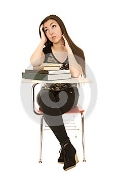 Attractive female student sitting at desk looking up