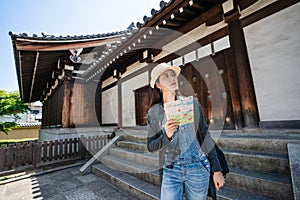 Travler holding guidemap and visiting. photo