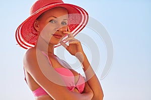 Attractive female wearing hat and swimsuit. Summer time, holiday trip, desire of adventure, relax concept. Copy space