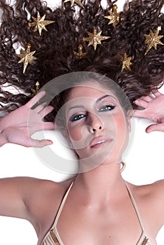 Attractive female woman's face with gold stars on her hair