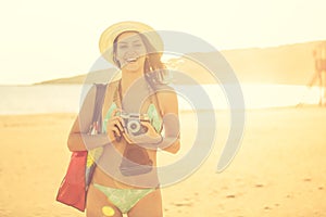 Attractive fit trendy modern hipster woman taking photos with retro vintage film camera.Lifestyle photographer