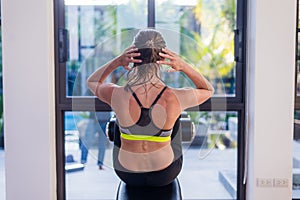 Attractive fit woman working out abs in fitness gym at luxury resort hotel with a great view during summer vacation