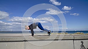 Attractive, fit, young woman doing burpees in slow motion, stock footage by Brian Holm Nielsen