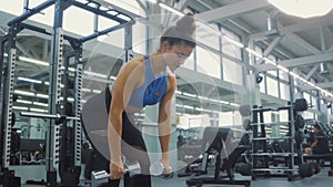 attractive fit young woman in sportswear practicing bent , dumbbell exercise