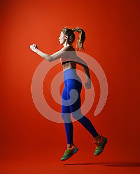 Attractive fitness girl in sportwear jumping