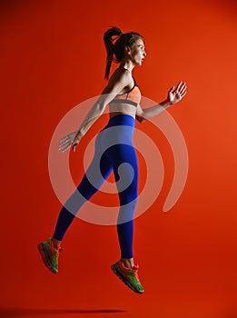 Attractive fitness girl in sportwear jumping