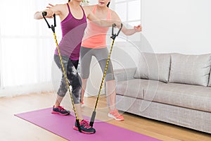 Attractive fitness girl using resistance band
