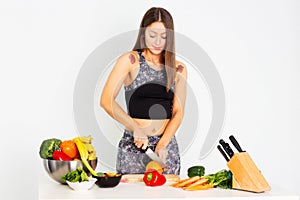 Attractive fitness woman, trained female Fit power athletic confident young woman bodybuilder cuting orange, Organic Food.