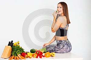 Attractive fitness woman, trained female Fit power athletic confident young woman bodybuilder eating veg , Organic Food.