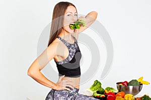 Attractive fitness woman, trained female Fit power athletic confident young woman bodybuilder eating veg , Organic Food.