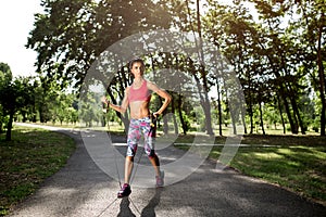 Attractive fitness young woman exercising with resistance band oudoor.