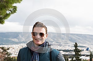 Attractive fourty year old man with sunglasses in a selfportrait at the Athens seaside