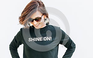 Attractive free feeling smiling woman in black sweatshirt