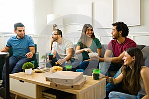 Attractive friends feeling happy watching the game on tv