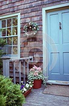 Attractive front entrance complements the cedar shake siding of this home.