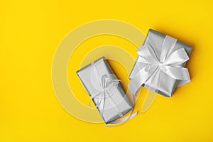 Attractive gift on the yellow background.