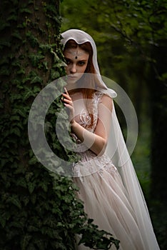 Attractive ginger elf woman in white dress and cape