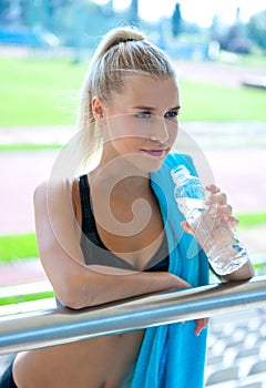 Attractive girl athlete with water bottle