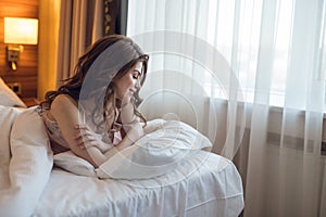 Attractive girl in bed in a hotel
