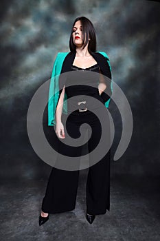 Attractive girl with black hair is posing in studio.  Style, trends, fashion concept.