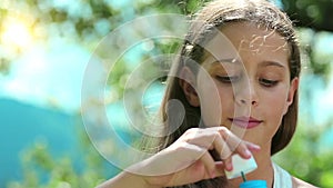 Attractive girl blowing soap bubbles